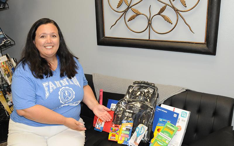 Tara Cantrell is pictured showing off a few of the many free school supplies that will be up for grabs at the Back to School Bash July 26.
