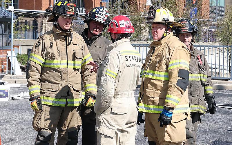 Fannin County firefighters Brett Crane, Earl Maddox, Leigh Hollins, Josh Curtis and Mike Miller plan a lesson at the FDIC conference.