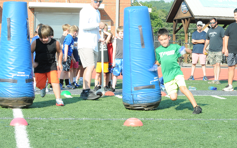 Coach Jack Roper sends new players through a drill to help them learn proper tactics to avoid blockers.