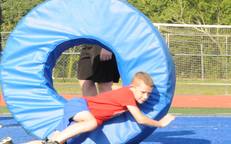 A young Rebel learns how to follow through with a tackle.