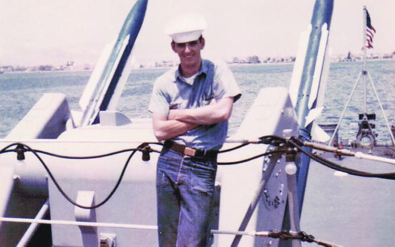 Danny Drake stands beside missiles aboard the USS Macdonough.