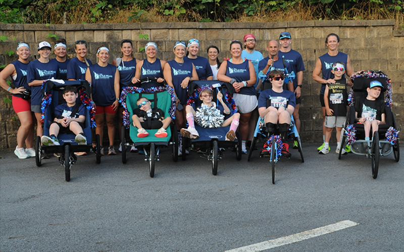 Blue Ridge Freedom 5K athletes Aiden Mullins, Gunner Patterson, Lilly Kicklighter, Ethan Kicklighter and Brady Smith, front from left, line up with volunteers from the Kyle Pease Foundation.