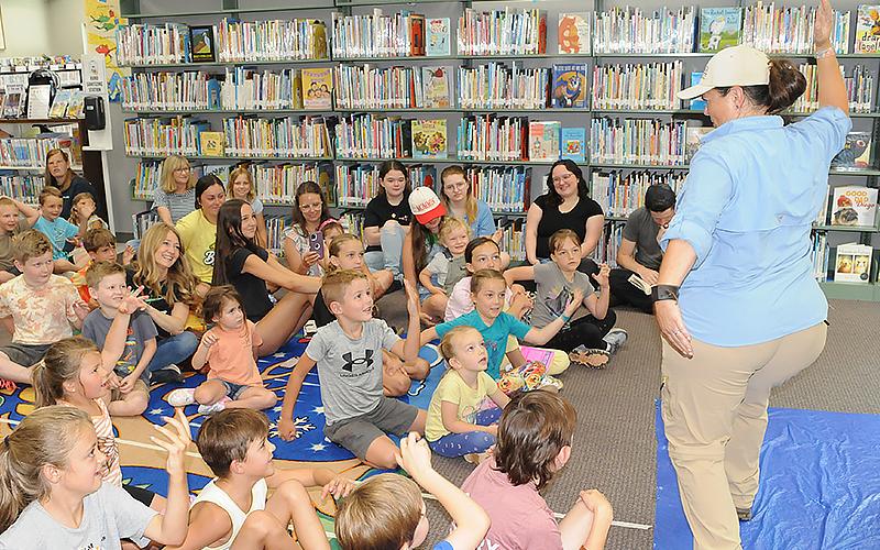 Wildlife Interpretative Specialist Kathy Church teaches a room of kids at the Fannin County Public Library about reptiles.