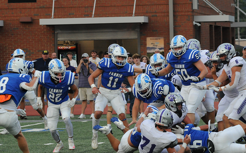 Fannin County’s defense swarms a Gilmer ball carrier Friday. The Rebels’ Reid Holloway (6) is on the bottom of the pile as, from left, Judah Wood (8), Conrad Head (22), Bryson Cole (11), Cayden Reece (62) and Isaac Watkins (50) converge.