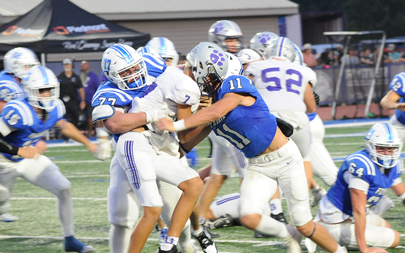 Jacob Green (77) gets help from Bryson Cole to stop a Gilmer ball carrier’s progress Friday night.