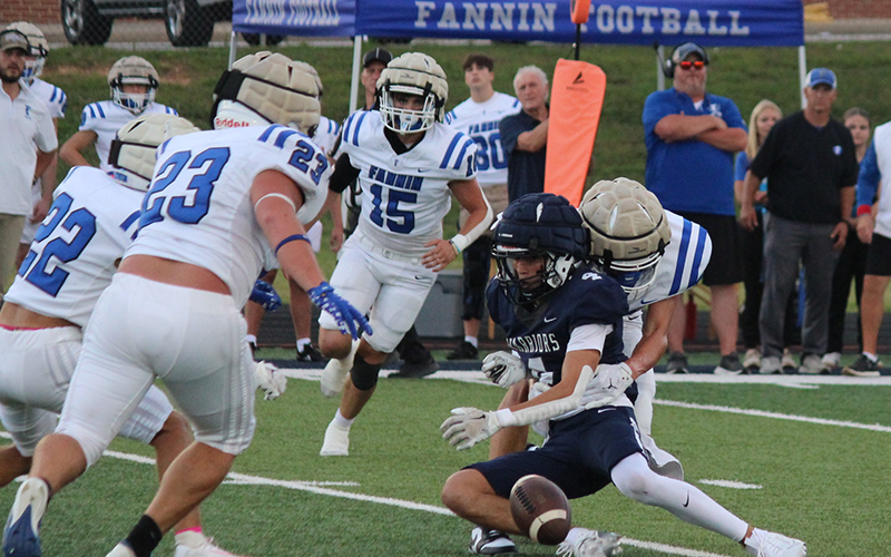 Rebels CJ Reece (23), Conrad Head (22), and Scott Waldrep (15) close in to recover a fumble knocked loose by a teammate in the scrimmage against White County Friday in Cleveland, Georgia.