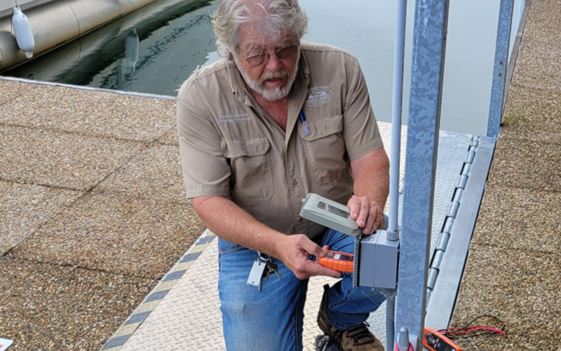 Fannin County Building Inspector Keith Nicholson checks a GFCI outlet on a dock at Lake Blue Ridge Marina.