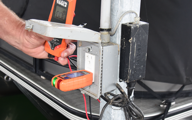 The green light on the device plugged into this Ground Fault Circuit Interrupter (GFCI) outlet indicates the outlet is working properly. When tested, the outlet cut off the flow of electricity in less than a second.