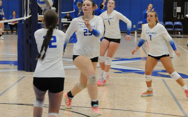 Lady Rebel Kelsie Key (12) sets up a return for Lady Rebels Addelyn Barnes (25), Maggie Ledford (7) or Tabor Pass (1) in action against the Hiwassee Dam Lady Eagles. The match was played Thursday, August 28, in the Fannin County High School gym.
