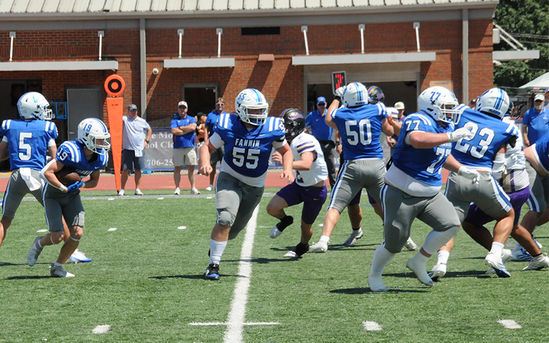 Fannin County’s Jasper Mealer (19) takes the handoff from Nate O’Neal (5) and heads around Union County defenders behind the blocking of Baylor Twiggs (55), Isaac Watkins (50), Jacob Green (77), and CJ Reece (23). The game was played Saturday afternoon in Blue Ridge after being postponed from the night before due to a shortage of officials.
