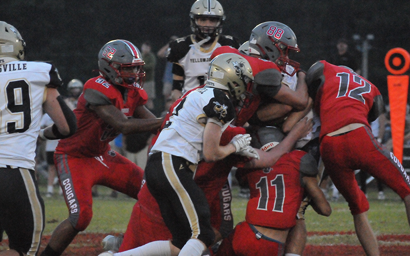Copper Basin’s Darrius Harris (52), AJ Pero (88), Nick Bird (11) and Logan Cochran (12) team up to shut down a Hayesville runner Friday night at Copper Basin.