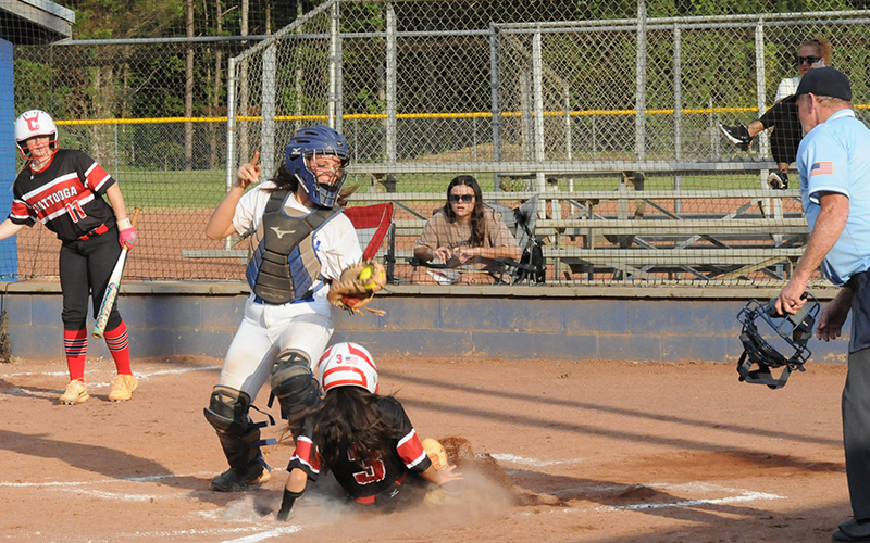 Sydney German takes a throw for the Fannin County Lady Rebels as an opponent slides into home plate in recent action in Blue Ridge.