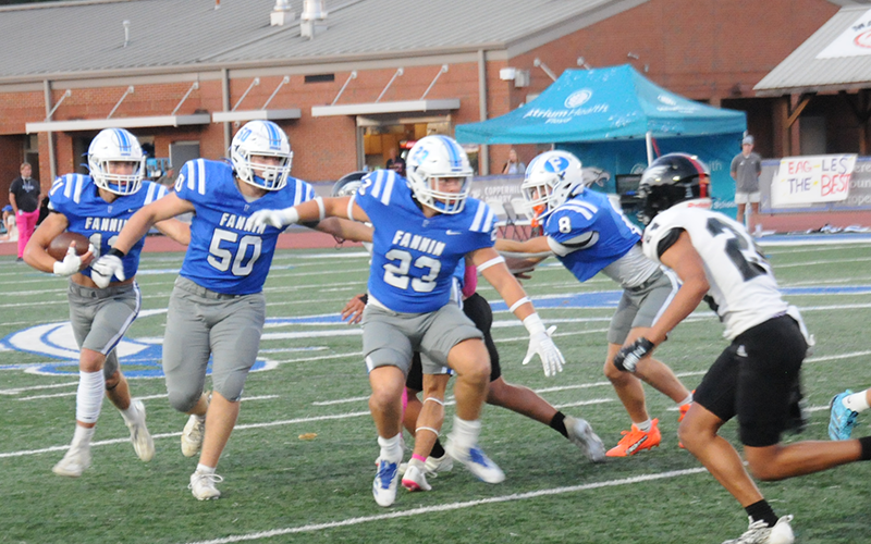 Fannin County’s Isaac Watkins (50), CJ Reece (23), and Judah Wood (8) clear a path for Bryson Cole (11) in action against the Coosa Eagles Friday at the Fannin County High School stadium.