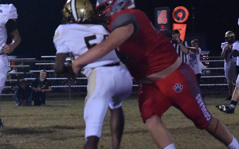In previous Copper Basin action this year, Dawson Pittman (left photo) looks downfield and Cooper Floyd (right) comes up with a big tackle.