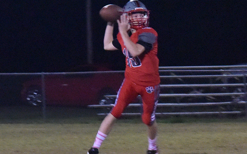 In previous Copper Basin action this year, Dawson Pittman (left photo) looks downfield and Cooper Floyd (right) comes up with a big tackle.