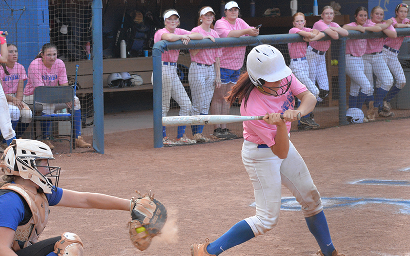 A Lady Rebel sets her eyes on a hit as her teammates look on in recent softball action. The Fannin County High School softball team earned a trip to the state playoffs with a game scheduled for today, Wednesday, October 15.