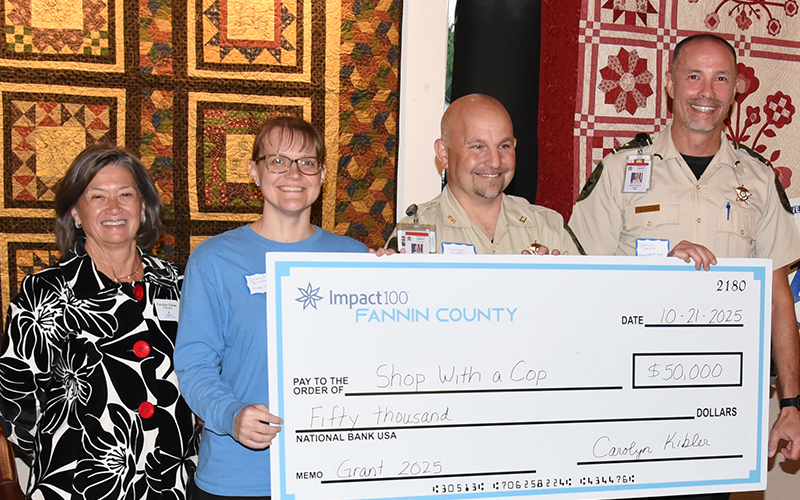 Carolyn Kibler presented Shop With A Cop representatives Sarah Dickey, Tommy Shook and Darvin Couch with an Impact100 Fannin grant for $50,000.