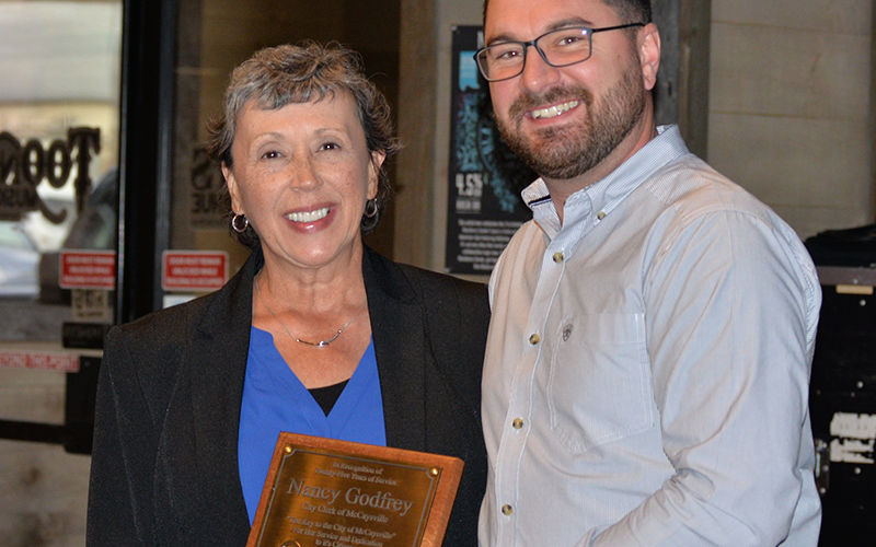 Nancy Godfrey receives a key to the city from Police Chief Michael Earley during her retirement reception Friday, October 24.
