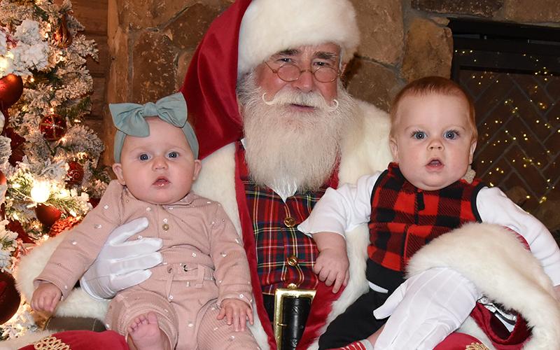 Santa Claus made an earlier than usual appearance this year, welcoming young and old alike to Serenity in the Mountains Sunday to support the Tour of Trees fundraiser to benefit the Fannin County Sheriff’s Office Shop With A Cop. Here, Allen Dickey and Lainey Jo Watkins share Christmas wishes. The Tour of Trees returns for a second day this Sunday, November 23, from 2 p.m. until 5 p.m. at Serenity.