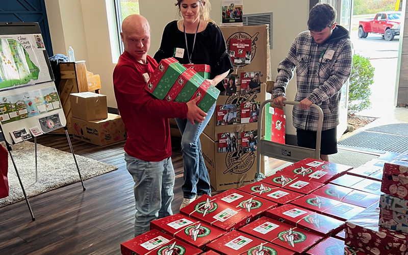 Samaritans Purse is having its annual shoebox drive for Operation Christmas Child November 17 through 24. Shoeboxes can be dropped off at The Ridge Community Church in Mineral Bluff during those dates. Riley Manders, Stephen Harris and Katie Jerauld are busy organizing shoeboxes.