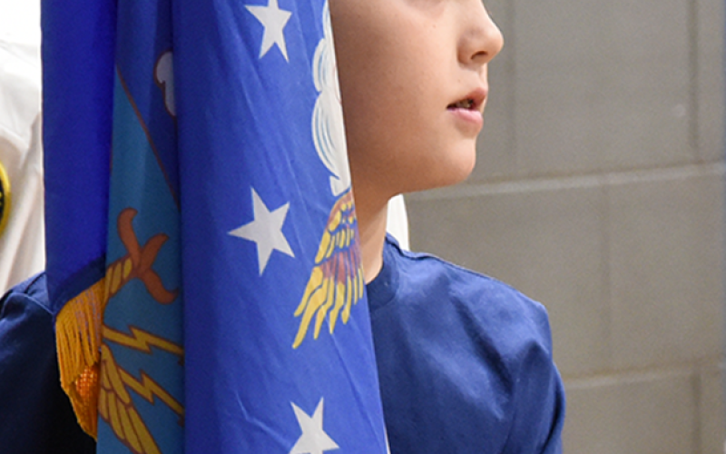 Jamison Kuder presents a military flag in the presentation of the flags during the Veterans Day ceremony at Blue Ridge Elementary School.