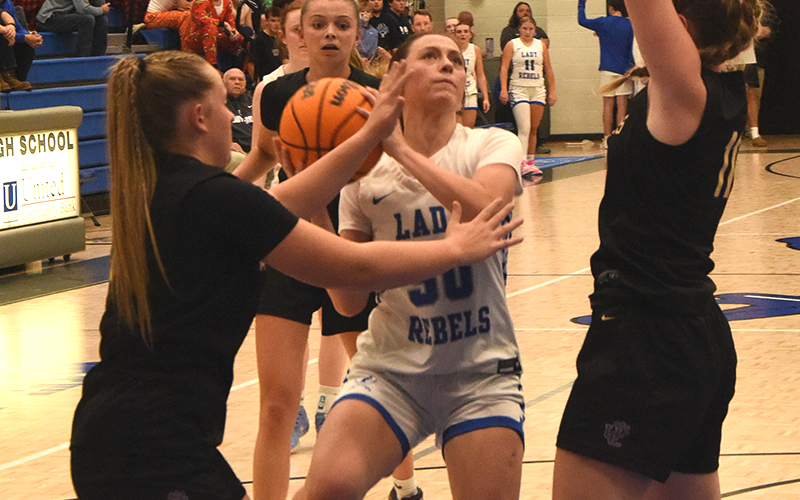 Avi Ethington battles through two defenders earlier this season for the Lady Rebels. She scored six points in Fannin County’s win over Morgan County.