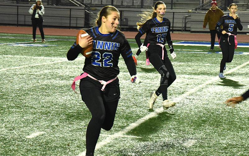 Lady Rebel flag footballer Bridgett Allen (#22) prepares to dodge her Mays County opponent in the state playoff game at home December 4. Lola Temples (#15) and Kendall Gaddis (#5) are also pictured.