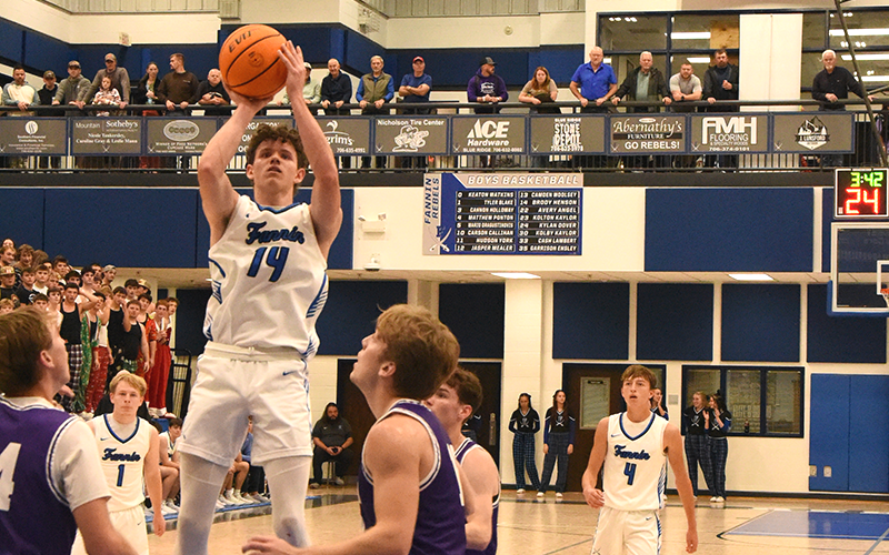 Brody Henson (14) eyes two of the 11 points he scored in Fannin County’s win over Union County Tuesday, November 25.