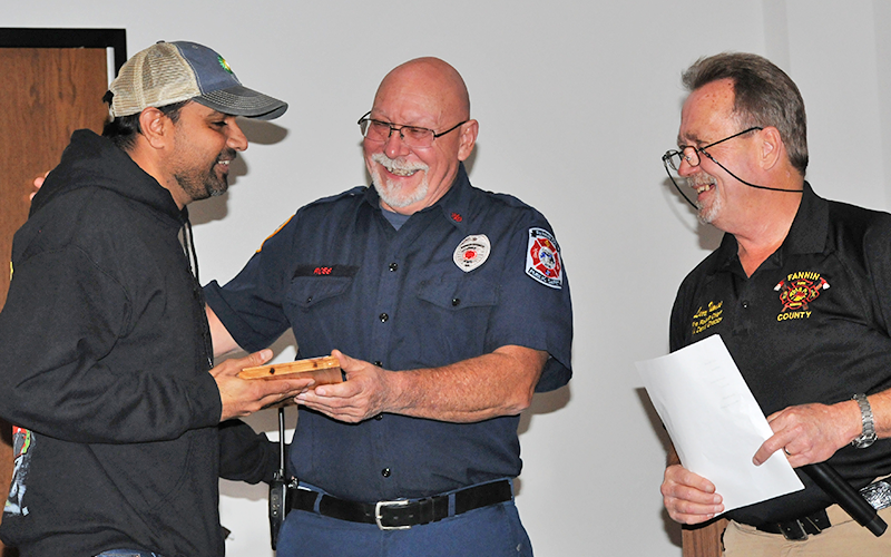 Harry Patel, left, received the Stanley Henson Volunteer Of The Year award at the Fannin County Fire Departments annual Christmas dinner. He is pictured with Deputy Fire Chief Rob Ross, center, and Fire Chief Larry Thomas.