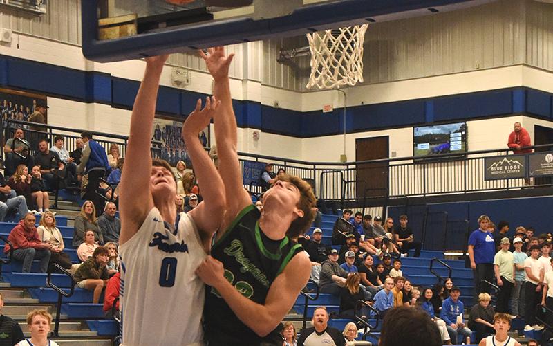 Keaton Watkins (0) battles for a rebound for the Fannin County Rebels earlier this season. He scored eight points in the Dade County win.