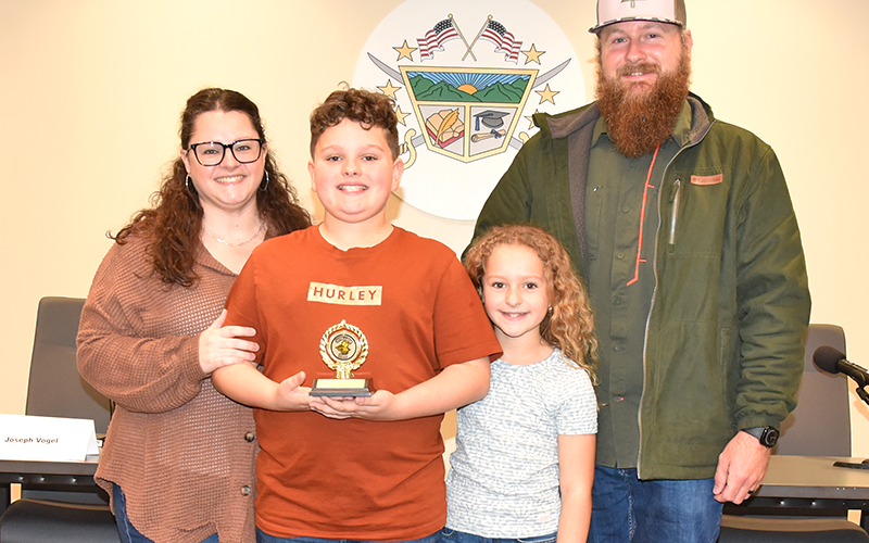 Lincoln Harriman is congratulated following the spelling bee by his parents, Brandi and Tyler Harriman, and his sister, Lily.