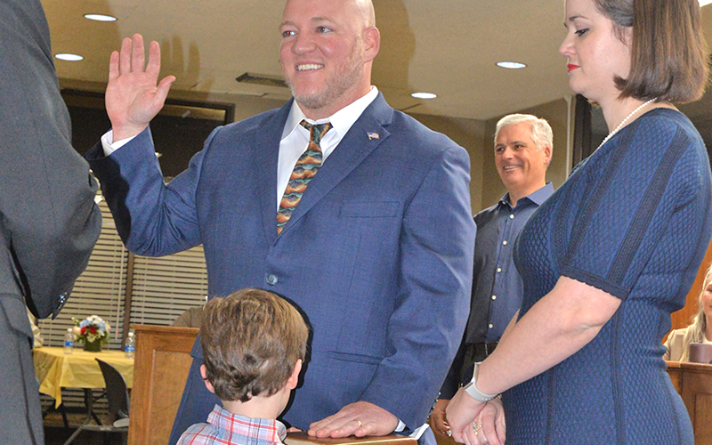 Blue Ridge Mayor Andy Rhodes takes his Oath of Office at City Hall Monday, January 5. He is shown with his wife, Sarah, and son, Winston, by his side.