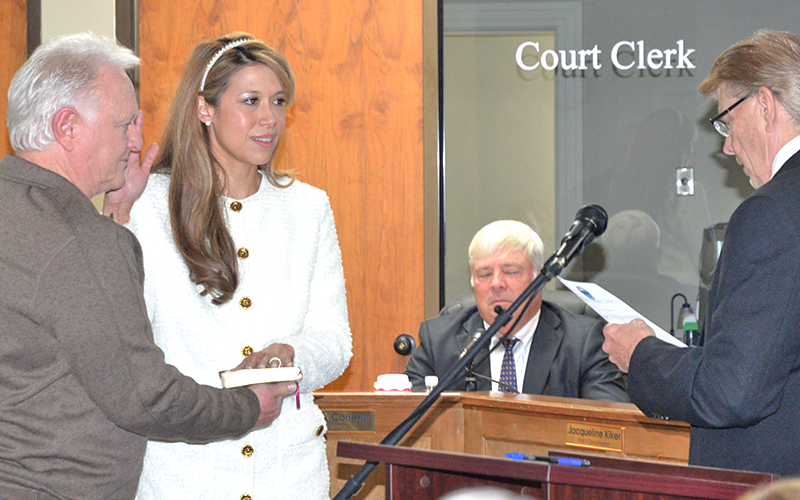Jacqueline Kiker is sworn onto the Blue Ridge City Council with Johnny Scearce, left,  holding the Bible and her father, Scott Kiker, right, performing the ceremony Monday, January 5, at City Hall.