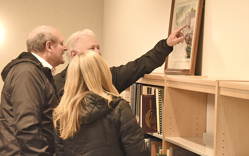 Commissioner Johnny Scearce, pointing, shared some historical knowledge of Blue Ridge with Commissioner Glenn Patterson and Fannin County Finance Director Sherri Walker. The photo Scearce is explaining hangs in the Genealogy Room of the new Fannin County Public Library.