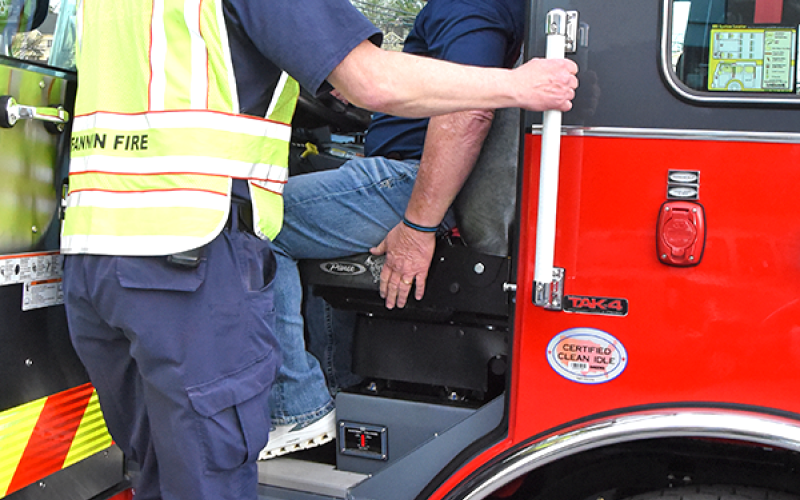 Fannin County firefighter Randy Epperson, standing, shows Post 1 Commissioner Johnny Scearce some of the new ladder truck’s safety features.