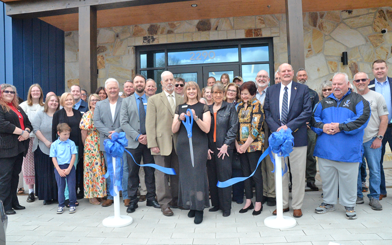 News Observer photo/Enola Patterson: Library Branch Manager Monica Clark cuts the ribbon at the Grand Opening Ceremony and Ribon Cutting of the new Fannin County Public Library March 7, officially marking the library open to the public. Surrounding her are the many officials, staff, and community members that helped make the opening of the new library possible.