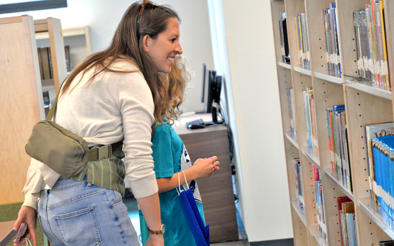 News Observer photo/Enola Patterson: A mother and her daughter search for the perfect books to read at the Grand Opening of the new Fannin County Public Library March 7.