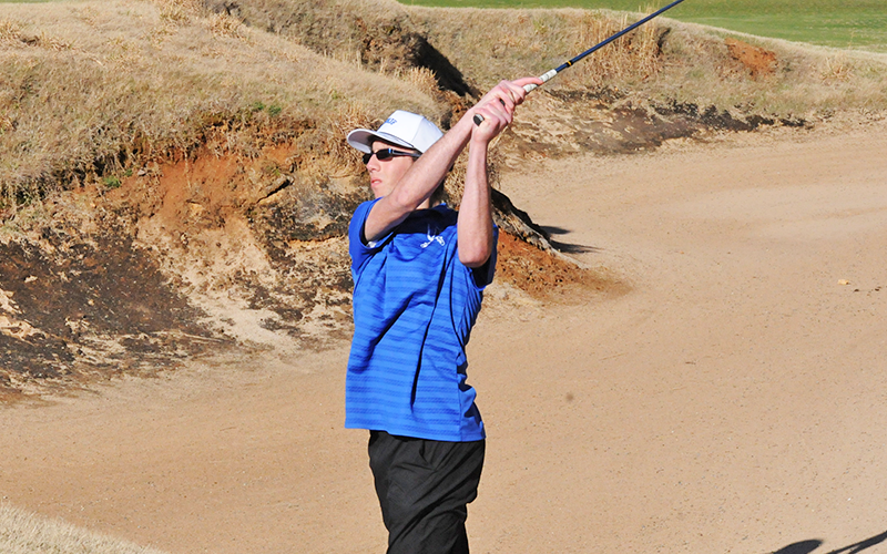 Cade Anderson hits out of a bunker.