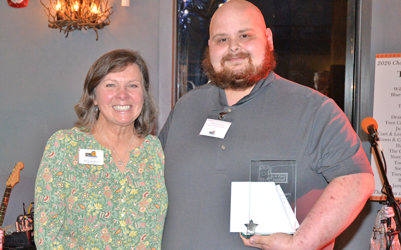 Snack in a Backpack board Secretary Mary Langford presents Tristin Davenport of Blue Ridge Food Lion the Business Champion award at the organization’s Champions for Children Fundraiser March 2.