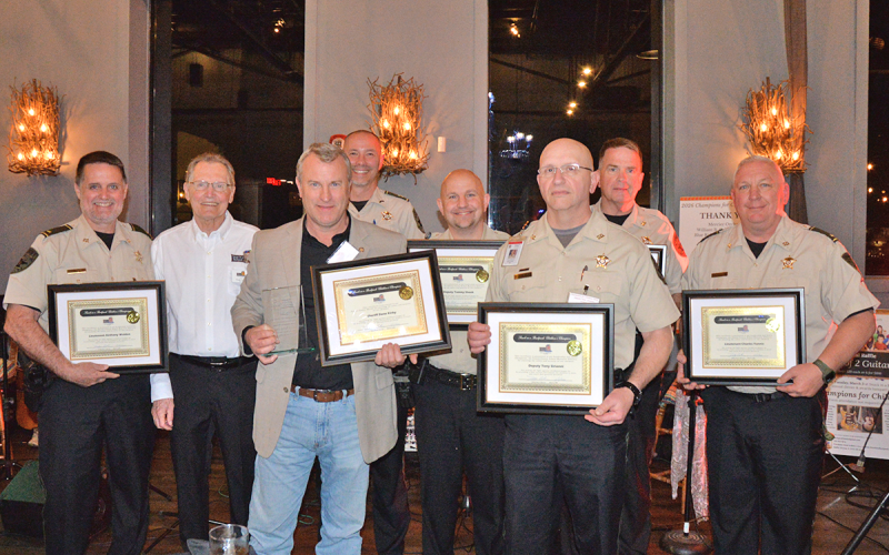News Observer photo/Mollie Morrow Fannin County’s School Resource Officers receive the Leadership and Safety Champions during Snack in a Backpack’s annual Champions for Children Fundraiser March 2. Shown are, from left, Anthony Walden, Frank Fulford with Snack in a Backpack, Sheriff Dane Kirby, Darvin Couch, Tommy Shook, Tony Sirianni, Eric Wood and Charles Yannis.
