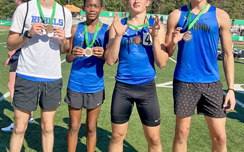 Winn Rickenbaker, Jamari Dunn, Braxton Cheatham and Hudson Lynch display their relay team medals from the Roswell meet.