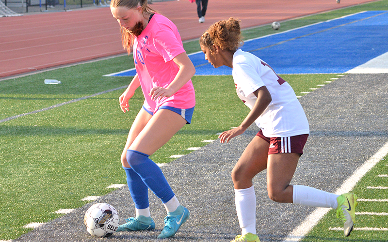 Fannin County Lady Rebel Marinn Denton (10) battles for the ball with a recent opponent at home.