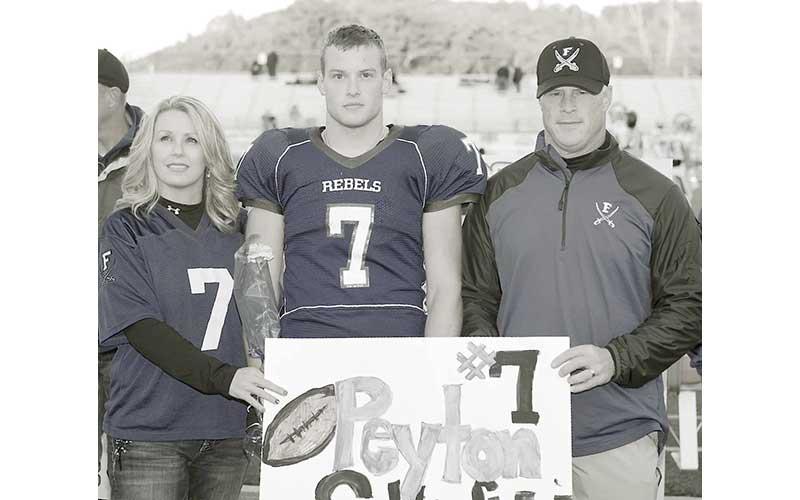 Submitted photo - Peyton Satterfield stands with his parents on senior night at Fannin County High School. He is the latest inductee into the Fannin County Sports Hall Of Fame Class of 2026.