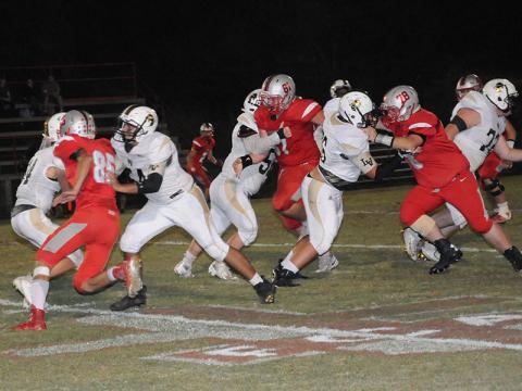 Copper Basin Cougars Cody Montgomery (85), Addison Hook (61) and Hunter Perry (78) get into the backfield and pressure the quarterback during Copper Basin’s region win against Lookout Valley Friday, October 4.