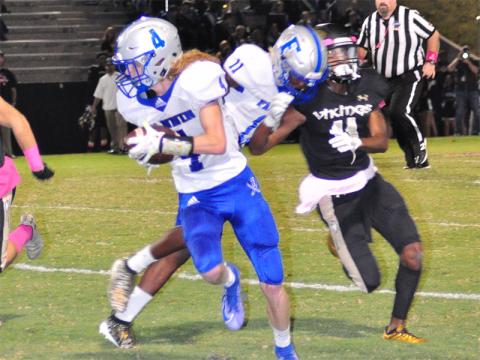 Fannin Rebel Andre Bivens (11) blocks a defender to keep the play alive as Cohutta Hyde (4) rushes down the field for a gain during the Rebels region win over East Hall Friday, October 11.