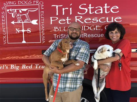 Rescue worker Gabe Waters holds Chester, pound puppy from a shelter in Alabama, while rescue volunteer Jan Eaton holds Dolly, a pup from Fannin County Animal Control. The pair of dogs were on a recent transport to Florida where they will be networked and adopted.