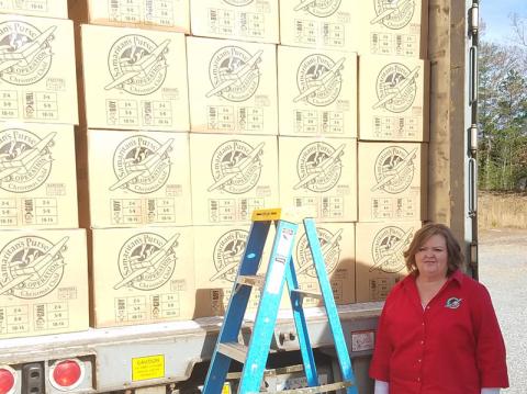 Debbie Dockery, Central Team Leader for the North Georgia Mountain Area Team for Operation Christmas Child, stands next to a semi-truck full of packed shoeboxes destined for children in need around the world.