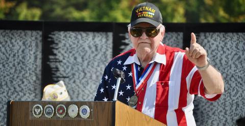 Vietnam War veteran George Nelson explains some of the history of the war to the crowd gathered for The Vietnam Traveling Memorial Wall memorial service Friday, October 4. The wall was on display in Blue Ridge from October 3 to 7.