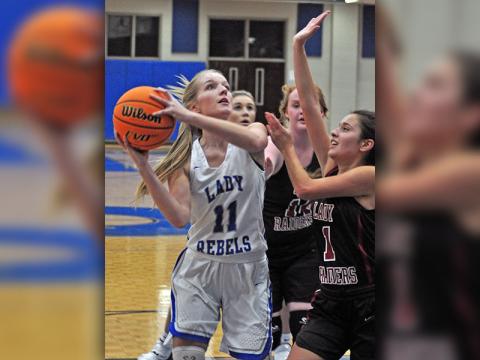 Senior Lady Rebel Saidee Collins fights through contact to shoot a layup during the Lady Rebels game against the Lady Raiders Tuesday, November 19.