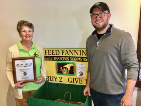 Feed Fannin was the recipient of a Starbucks Foundation Neighborhood Grant in the amount of $1,500. Here, Feed Fannin representative Priscilla Cashman and Starbucks Manager Jonathan Barnes stand beside the big green food donation box stationed at the stand-alone coffee shop on Progress Circle in Blue Ridge.